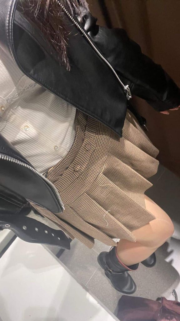 leather jacket and pleated skirt outfit