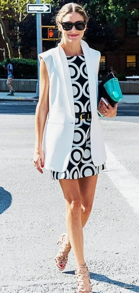 white sleeveless blazer and black dress